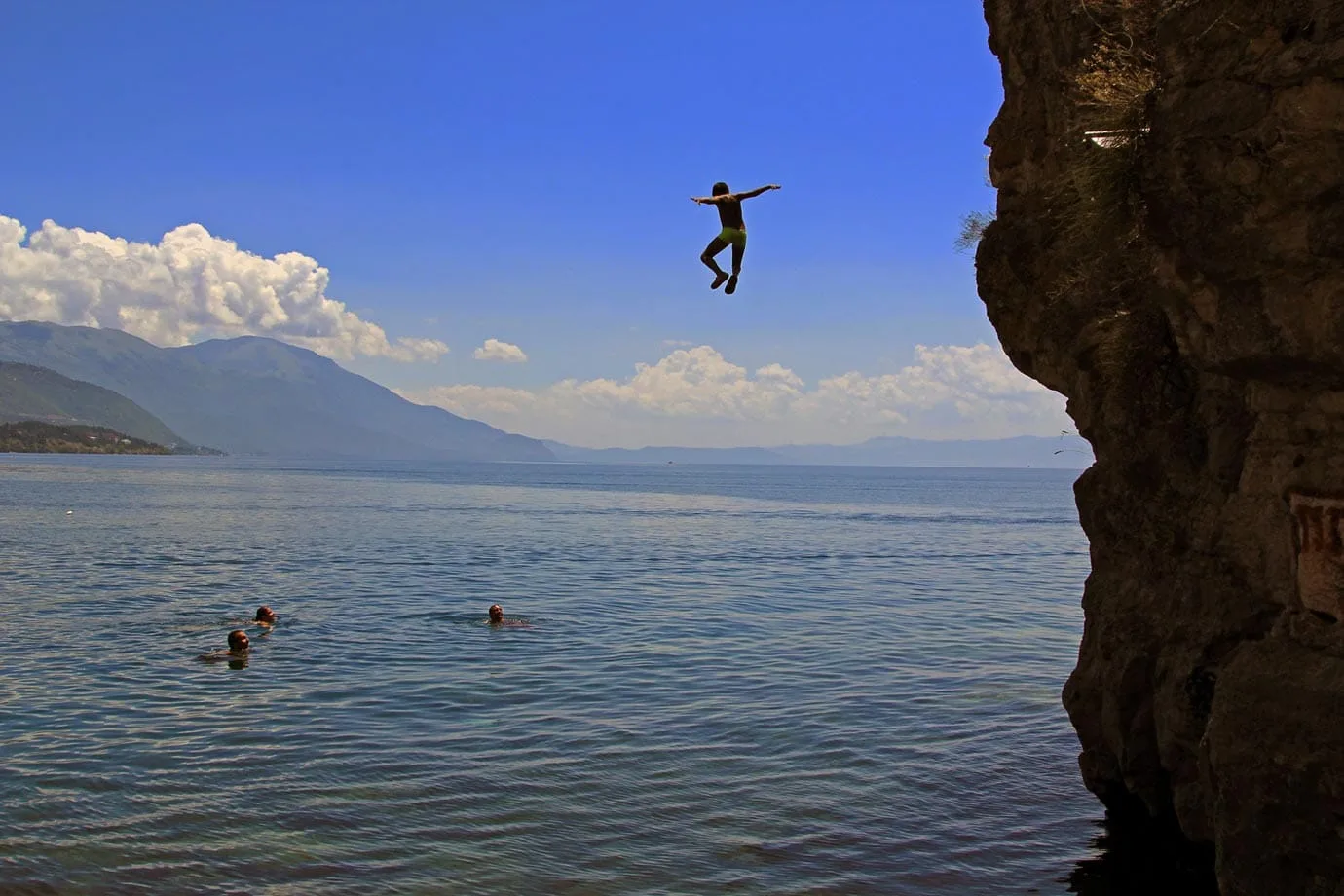 A young boy cliff jumping at Kaneo Beach