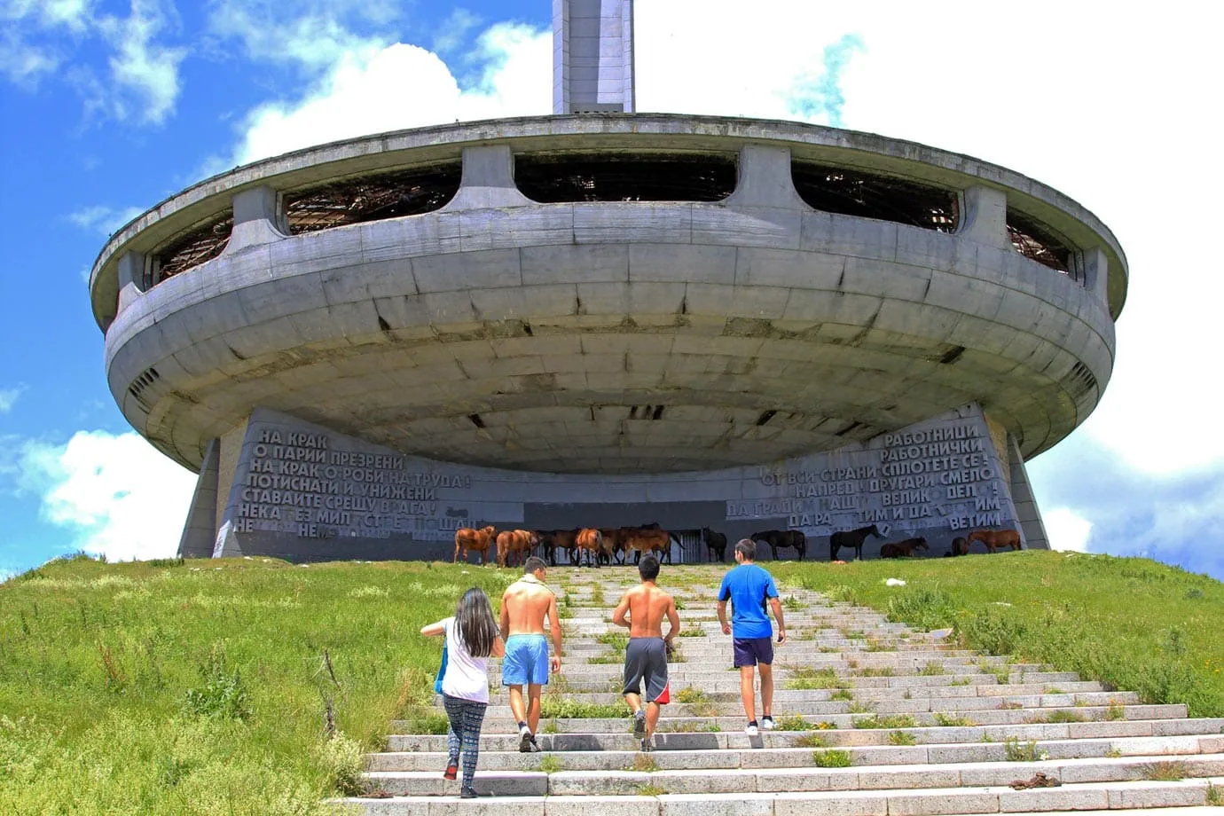 Messages written in giant Cyrillic letters on either side of the main entrance greet you as you walk up the stairs to Buzludzha