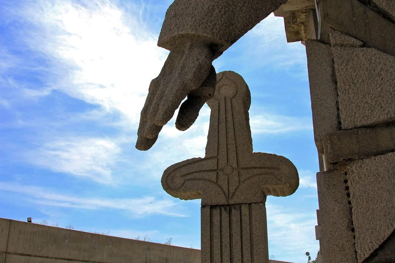 A hand touches the sword; this is all about power