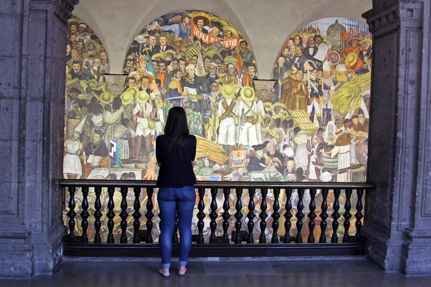 Looking at a mural in the National Palace of Mexico