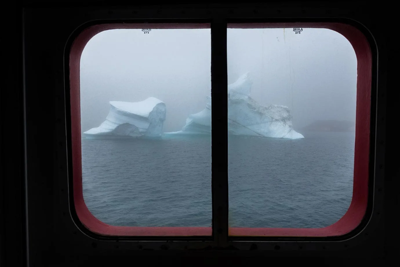 Icebergs floating past a window