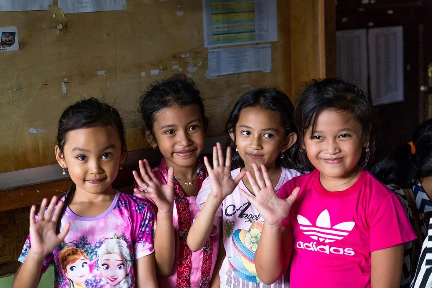 Kids waving in Indonesia
