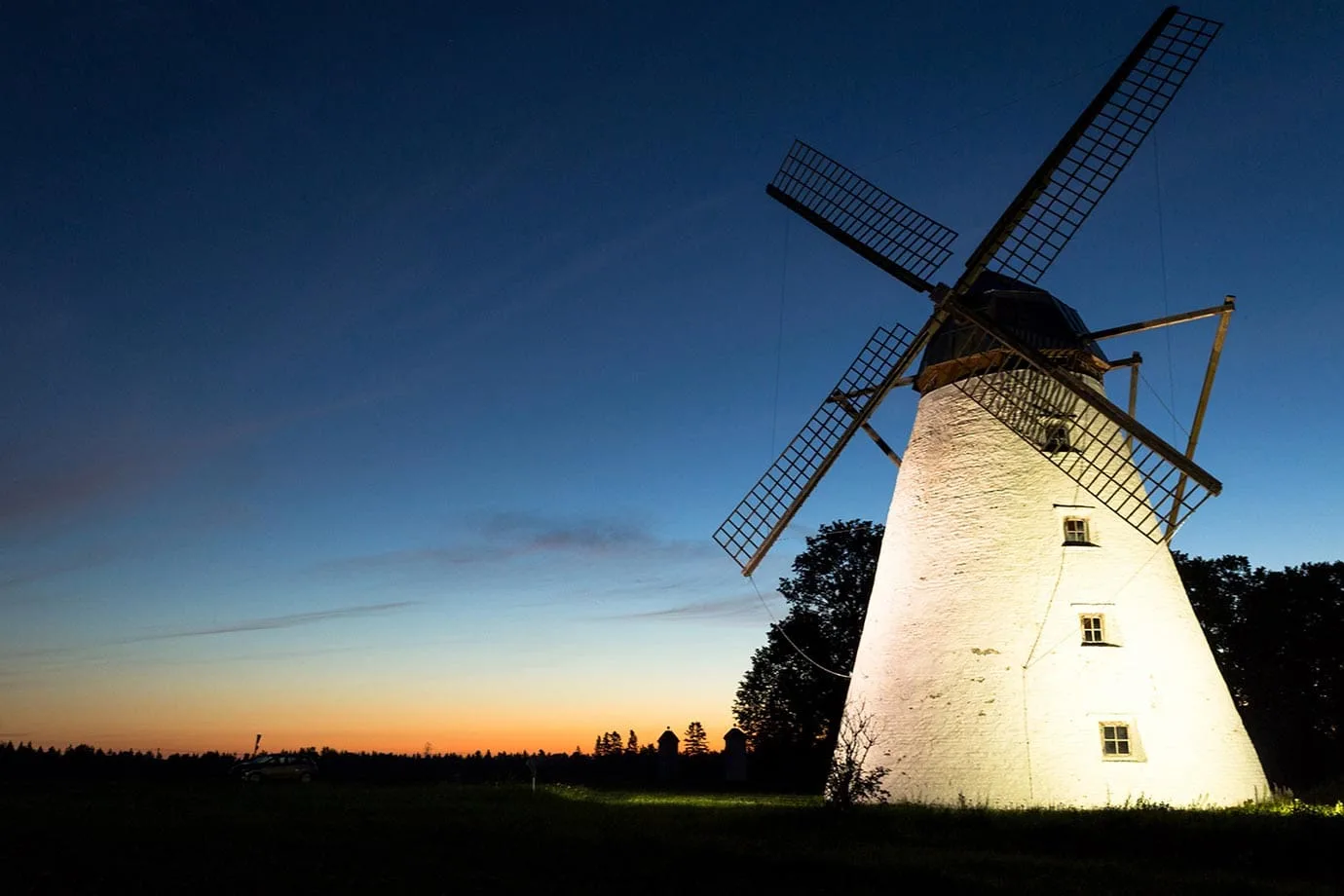 Windmill lit up at night in Estonia