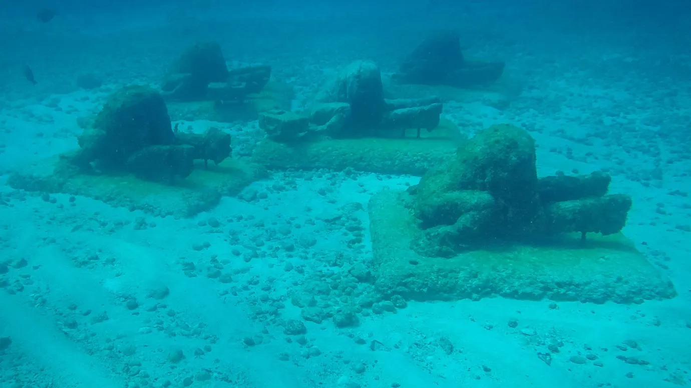 These are the businessmen with their heads buried in the sand - pretty weird, right? underwater museum mexico