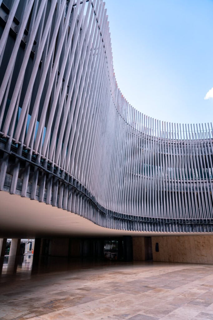 Modern architectural building with curved metal facade in Merida, Mexico.