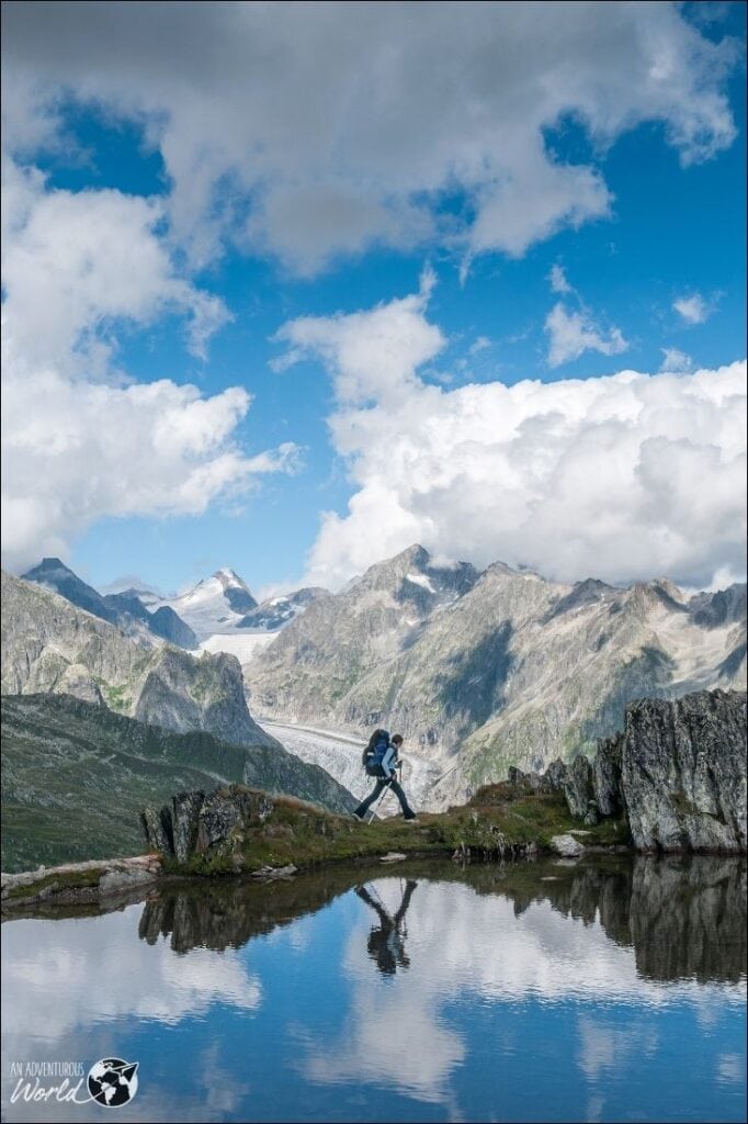 hiker by a lake in the mountains