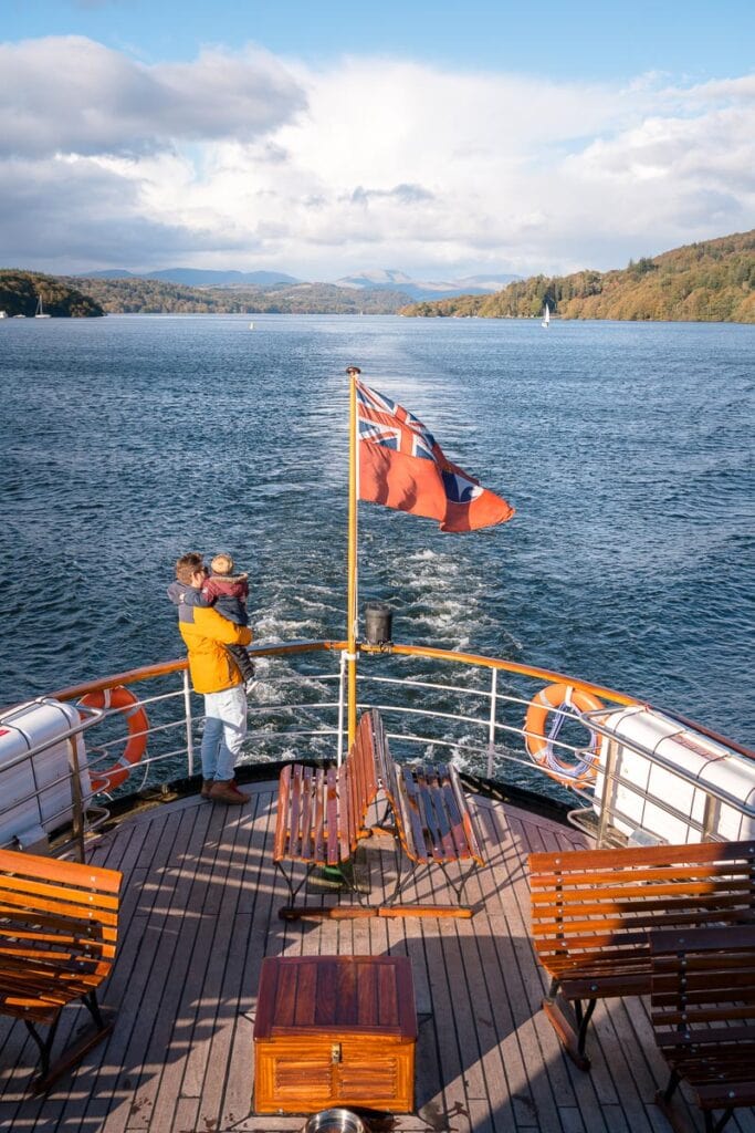standing on the back of the boat to lakeside